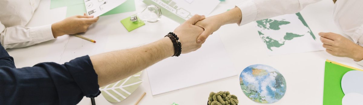 businessman-shaking-hands-with-his-partner-desk businessman-shaking-hands-with-his-partner-desk